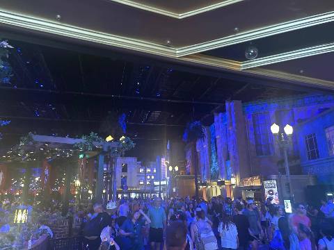 a crowded indoor plaza styled as a night street