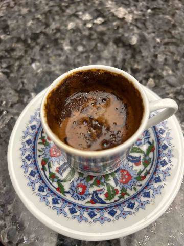 Xanadu, Belek a cup of dark coffee on a floral patterned saucer, btw this is a classical Turkish cup, if you are seeing your Turkish coffee 