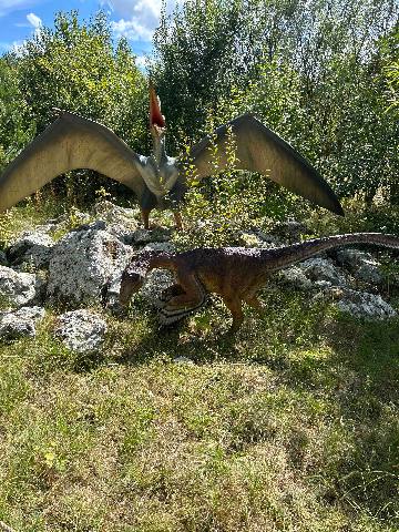 dinosaur models in a park setting