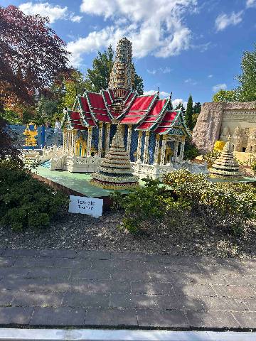 a miniature model of a temple in an outdoor park