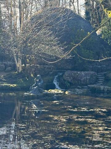 Dublin, Kildare, a garden statue by a pond and stone structure