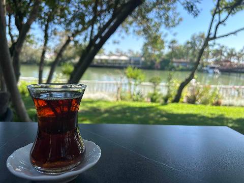 Selectum, Belek, a glass of tea on a table overlooking a river